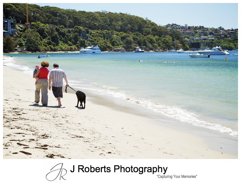 Family walking along the beach with their dog - sydney family portrait photographer